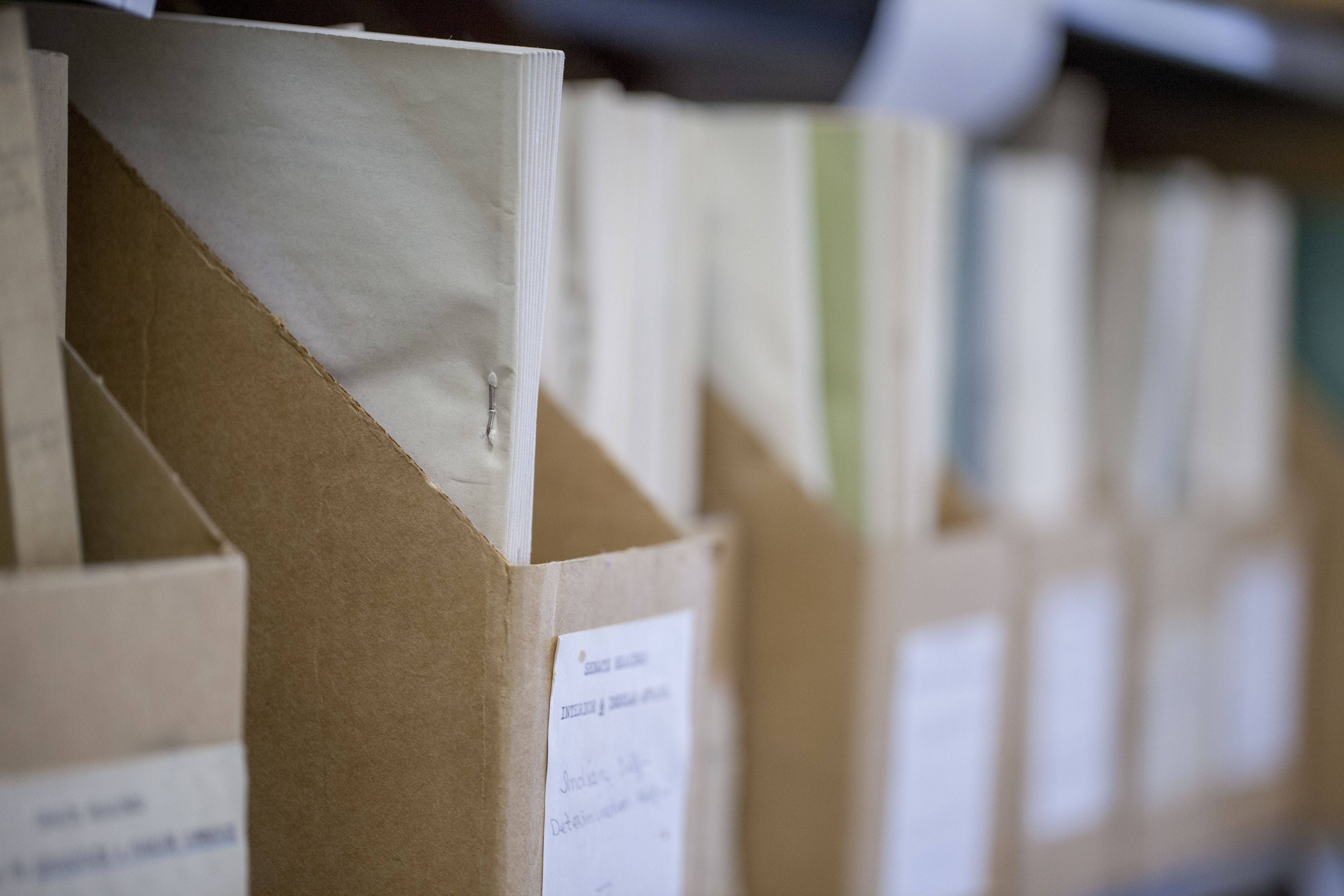 papers in a cardboard file box